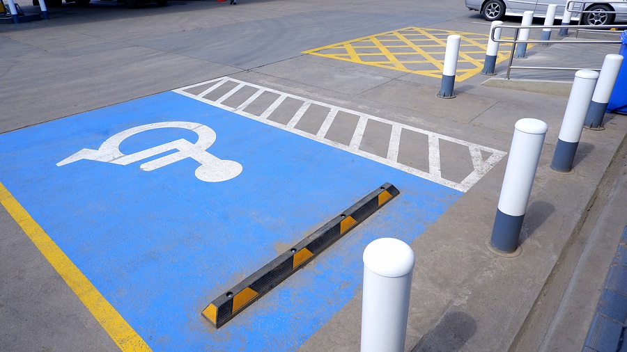 Parking lot with a handicap zone and parking rods.