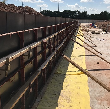 Support structure for molding a retaining wall
