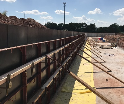 Support structure for molding a retaining wall