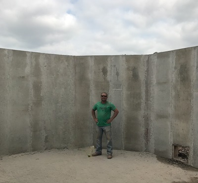 Large retaining wall with a person standing in front of it.