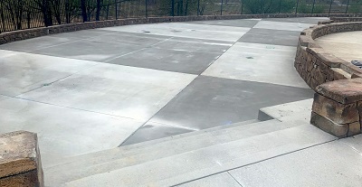 Concrete walkway that has been colored differently to create a checkered pattern